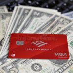 Bank Of America Visa Payment System Card On A Laptop With US Dollars